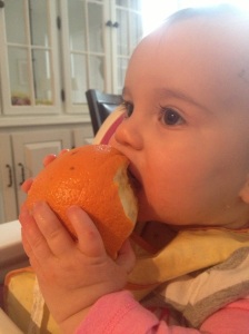 Toddler eats whole orange